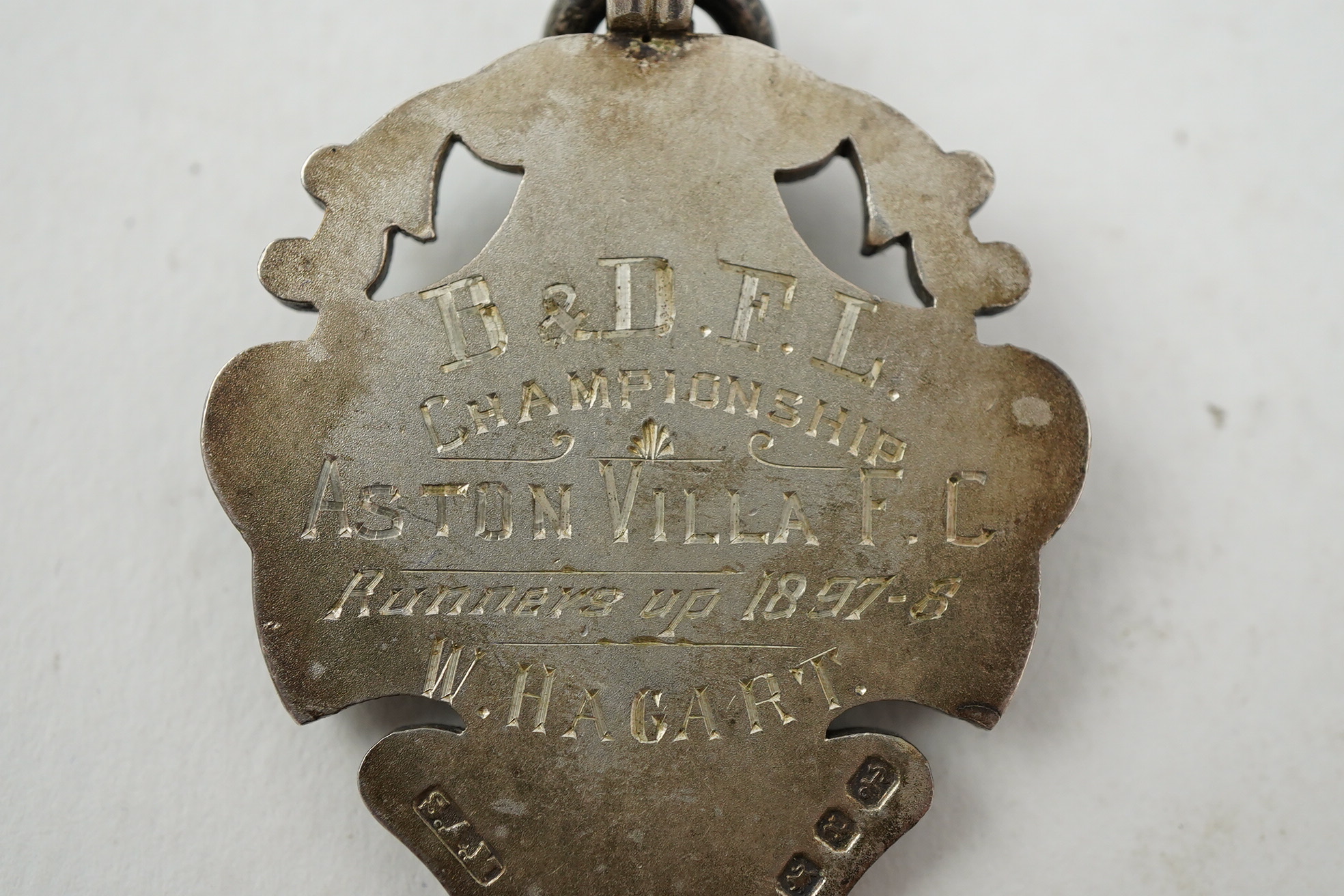 Aston Villa Football Club interest :, a late Victorian silver football medal, inscribed 'B & D.F.L. Championship, Aston Villa F.C. Runners Up 1897/98, W. Hagart [sic]', makers S.A.M., Birmingham, 1897, 44mm, in case of i